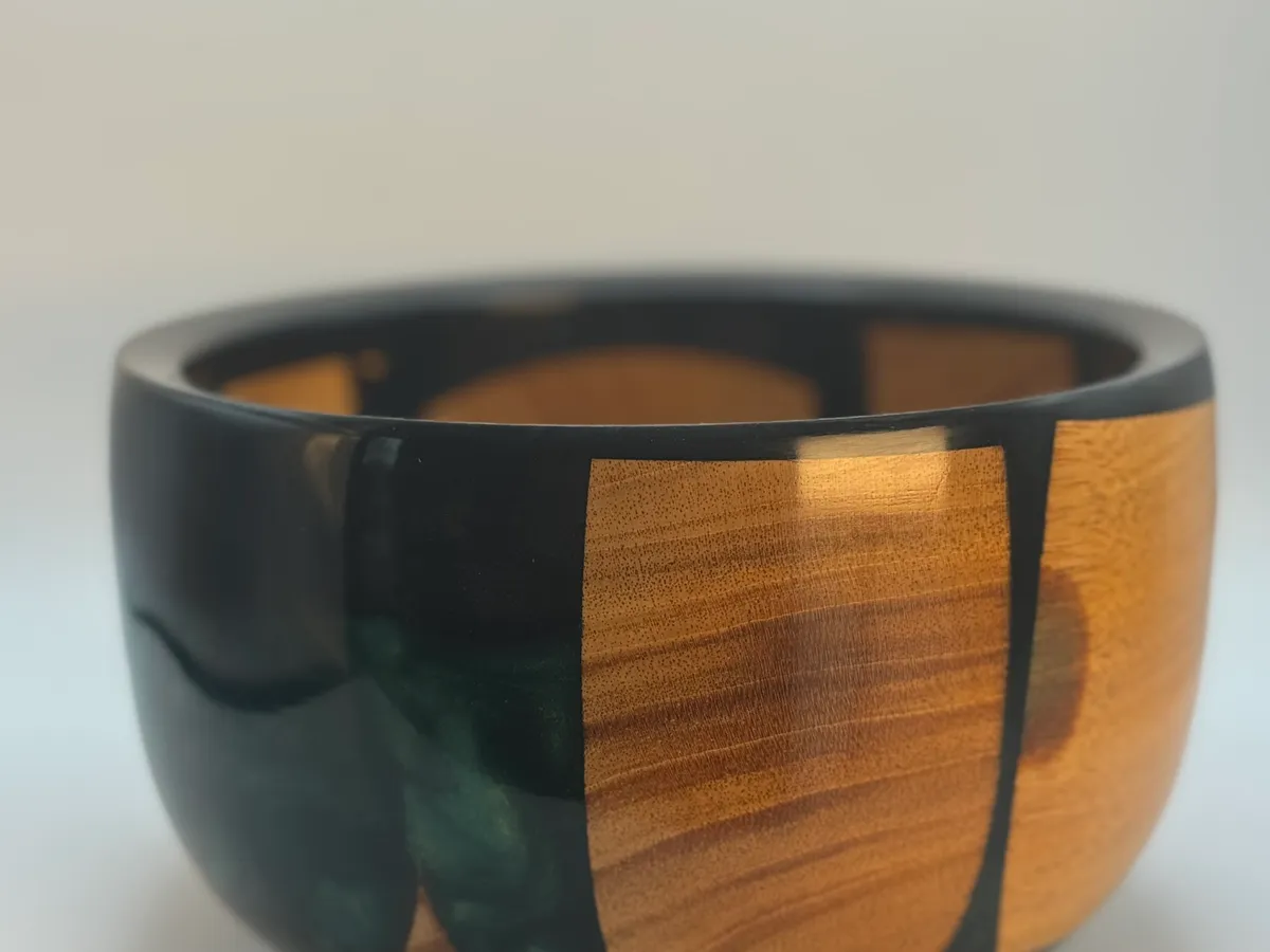 Dark green resin and cherry wood scraps forming a decorative hand-turned bowl
