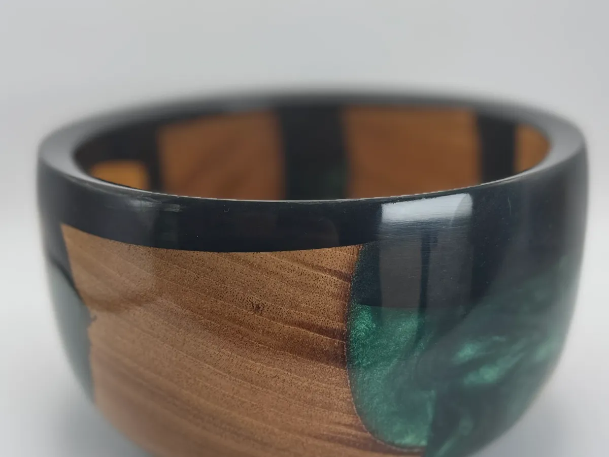 Close view of cherry wood grain beside deep green resin