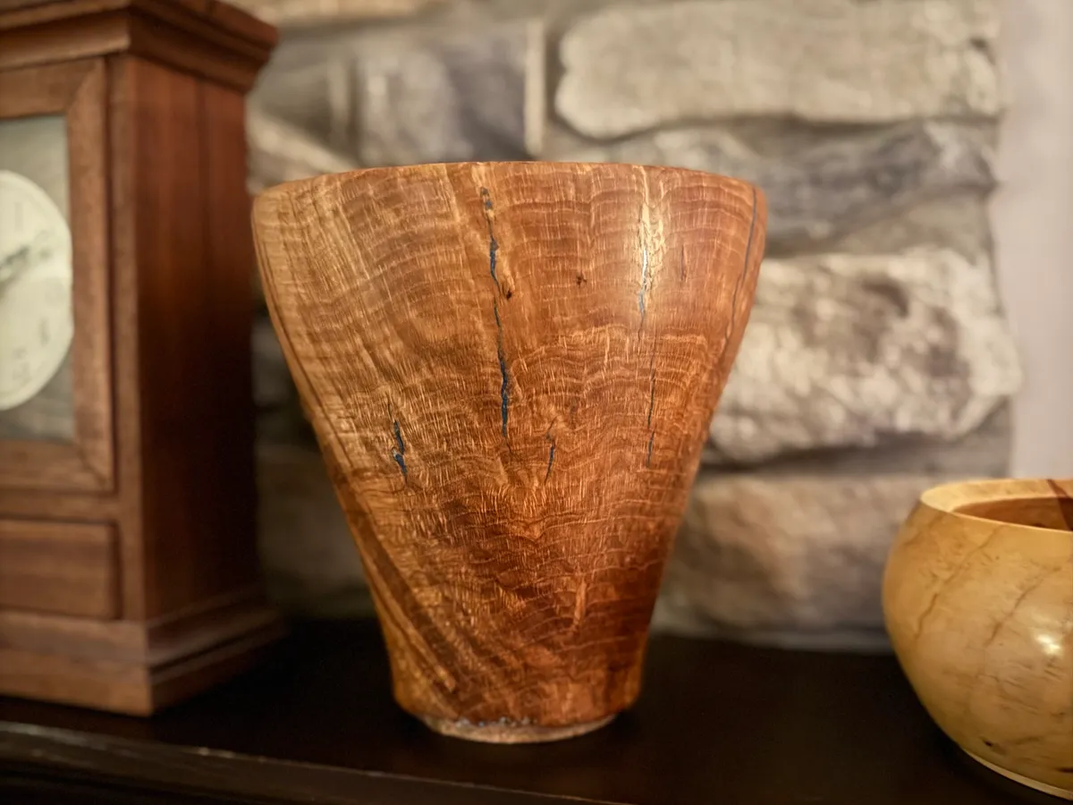 Side view of white oak burl vase with wide flared top and smaller foot