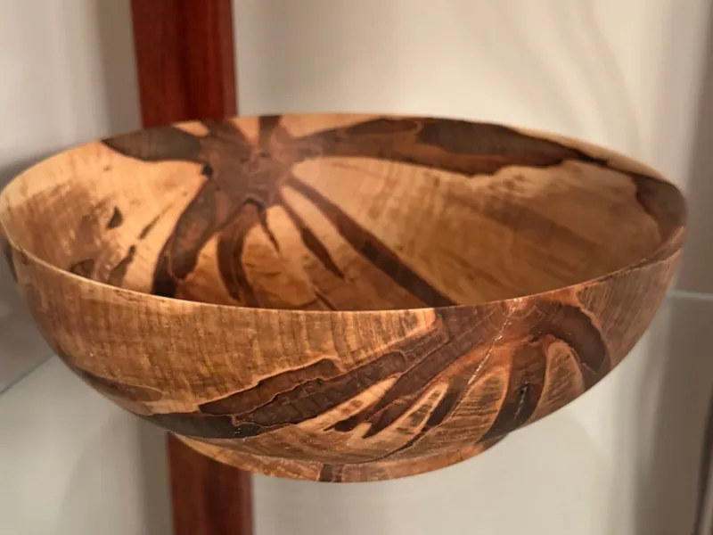 Hand-turned spalted maple bowl showing dramatic dark zone lines through a pale background