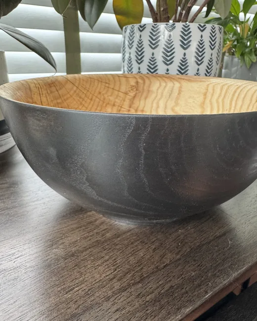 Finished ash bowl with dark exterior and warm wood interior