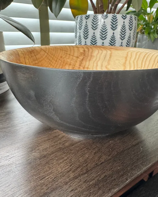 Finished ash bowl with dark exterior and warm wood interior