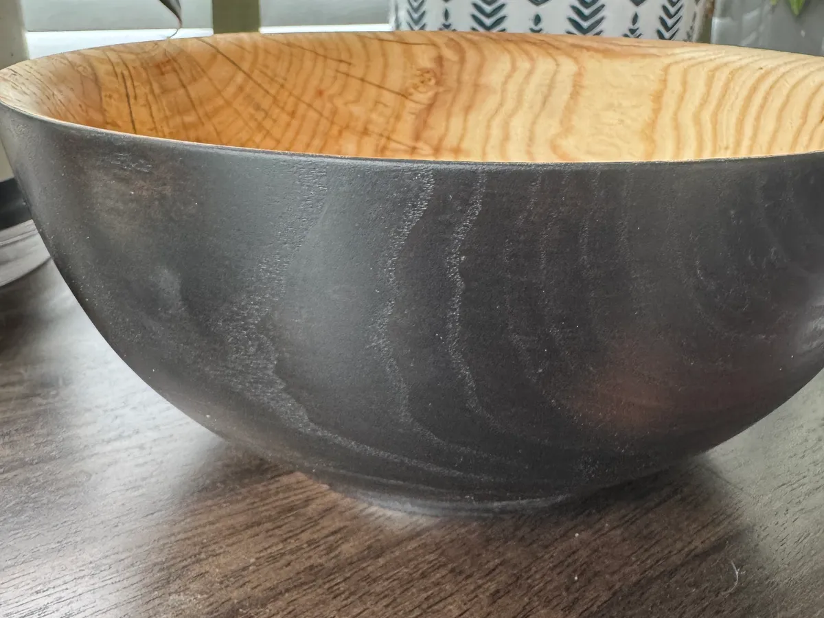 Blackened ash vessel with matte Rubio Black exterior and warm natural ash interior