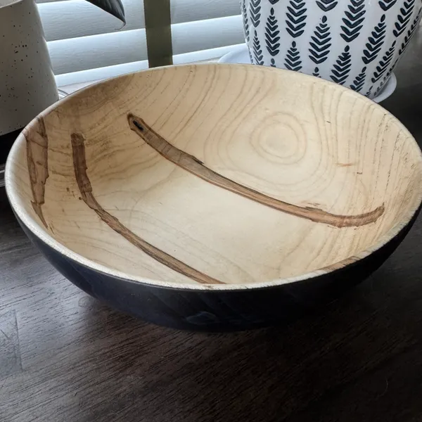 Top view of ambrosia maple bowl showing natural beetle figure and bark inclusions through color treatment