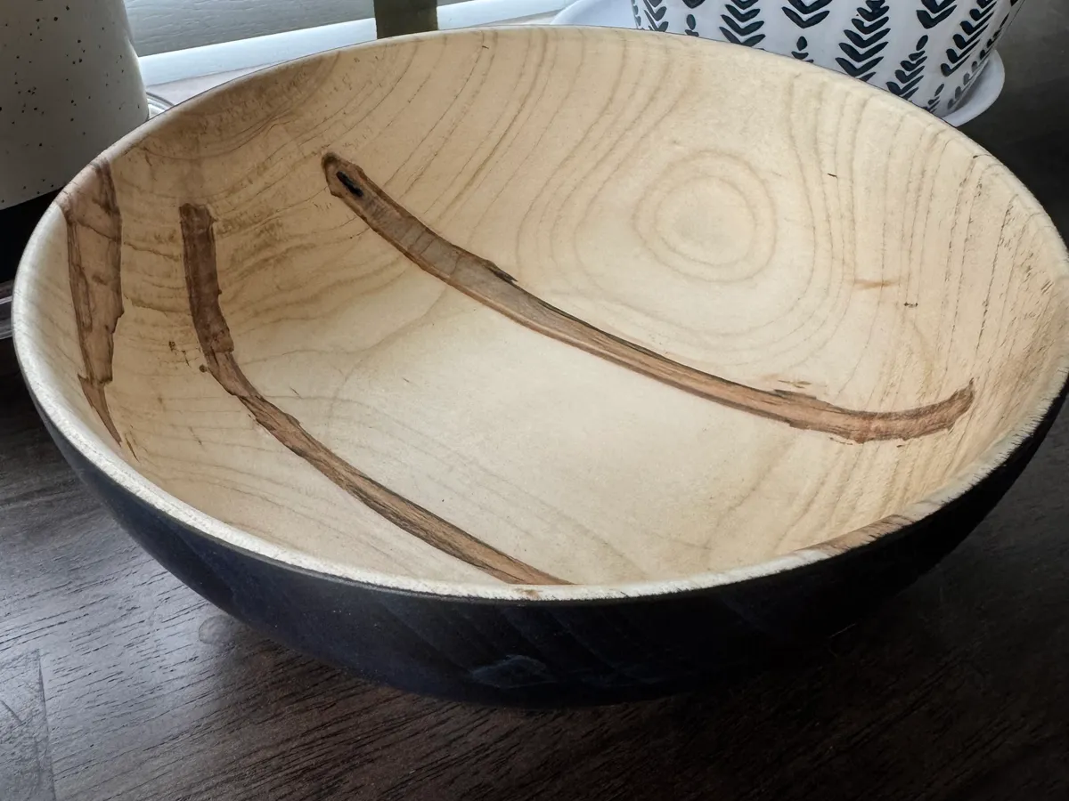 Top view of ambrosia maple bowl showing natural beetle figure and bark inclusions through color treatment