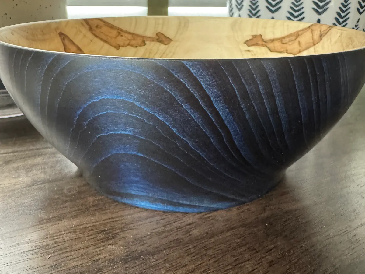 Color-enhanced ambrosia maple bowl with blue-black exterior and pale natural interior