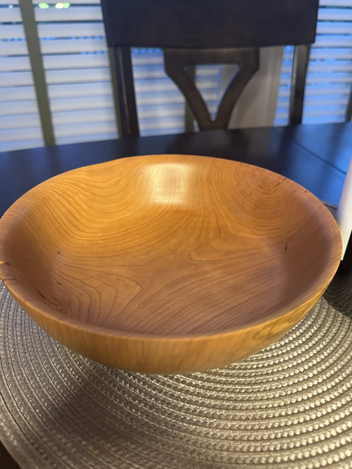 Cherry wood bowl with honey-amber grain and an open dining-table form