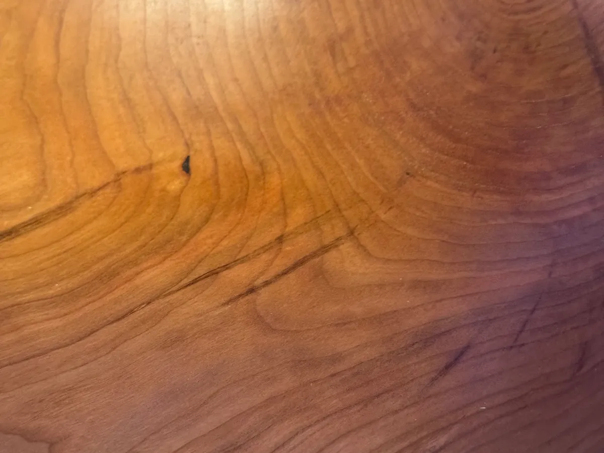 Close-up of cherry wood bowl interior showing rich amber grain and flowing growth rings