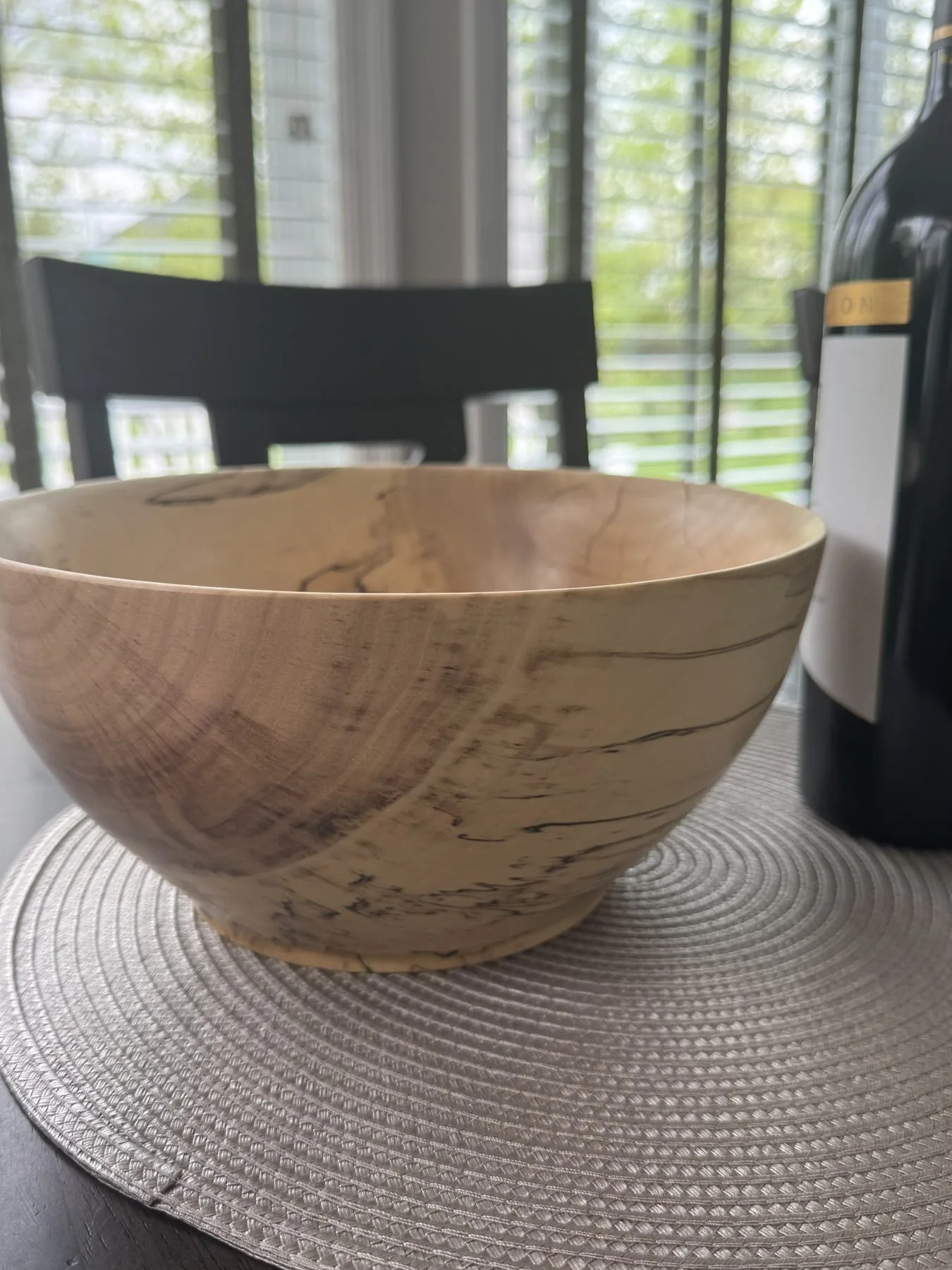 Close-up detail of spalted maple bowl showing dramatic black zone lines and fungal figure in pale wood