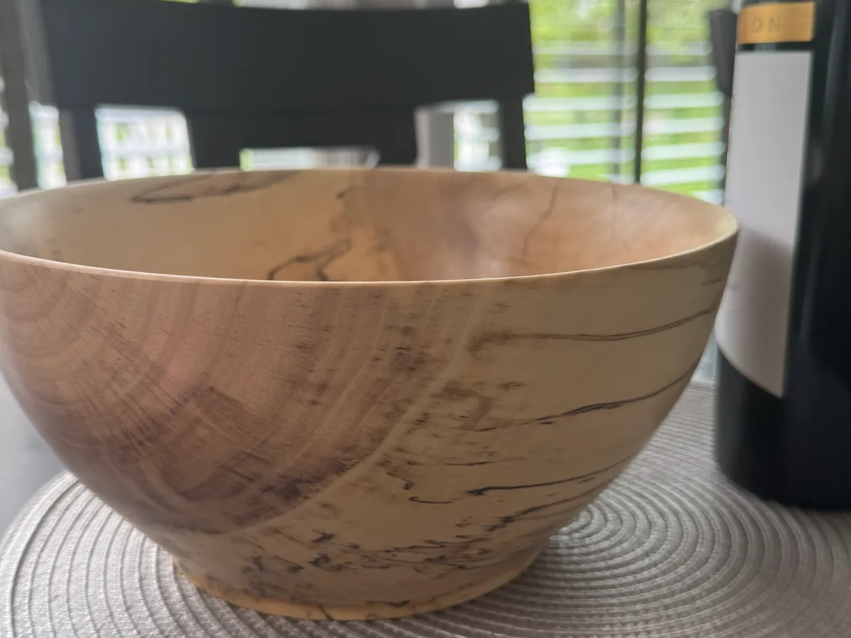 Close-up detail of spalted maple bowl showing dramatic black zone lines and fungal figure in pale wood
