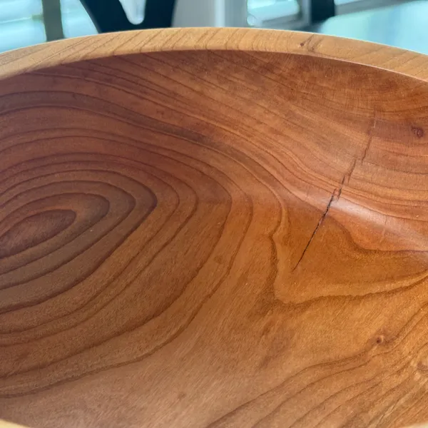 Interior of cherry wood bowl showing concentric grain rings and warm amber tone