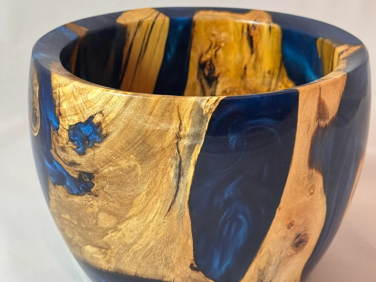 Electric blue resin bowl showing glossy finish, apple wood figure, and rounded form