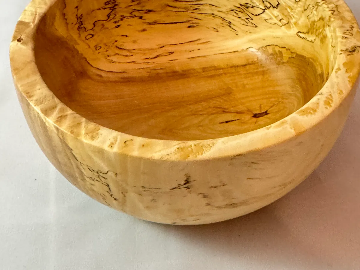 Small spalted maple bowl with dark zone lines and a compact rounded form