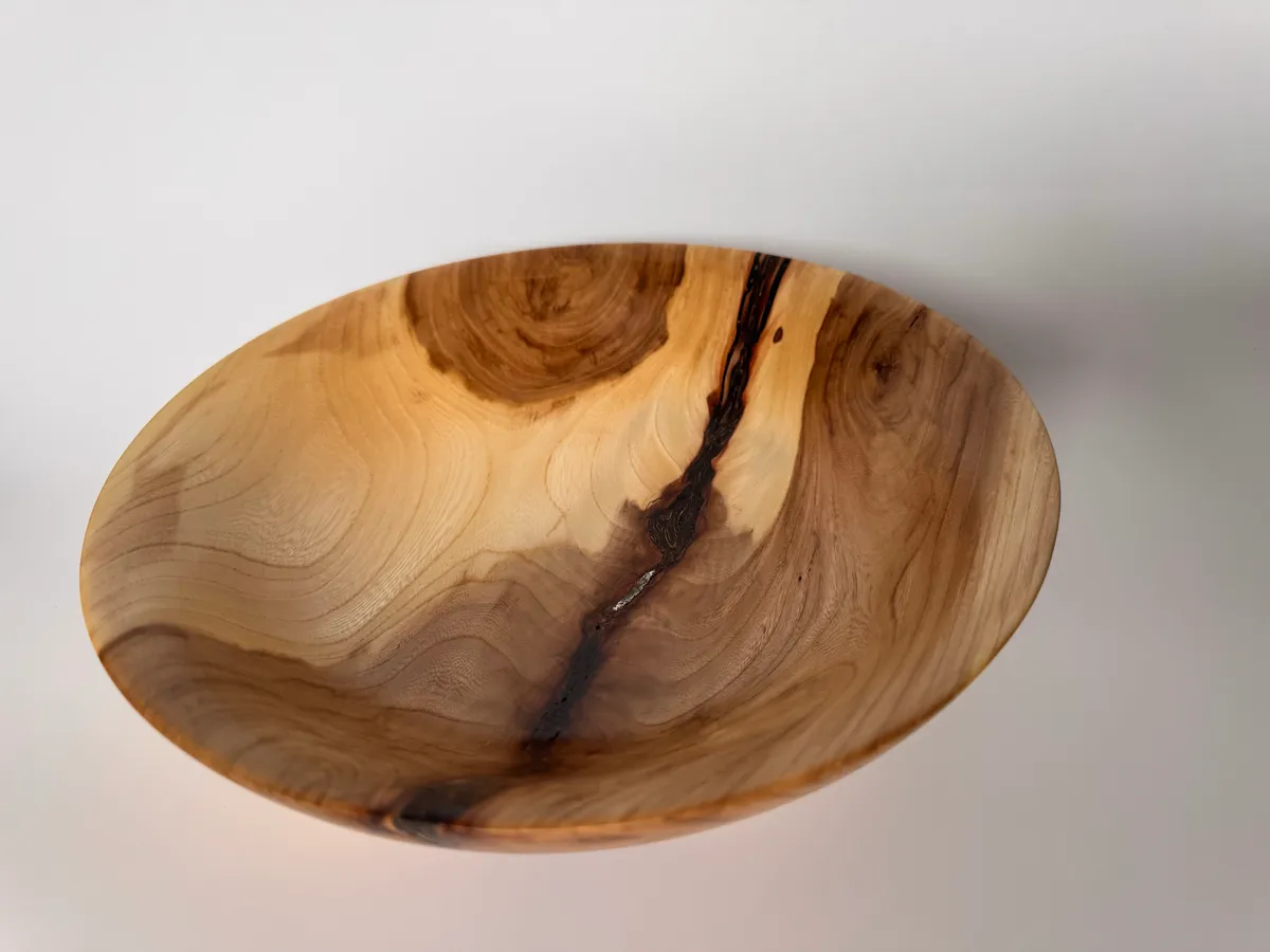 Apple wood bowl with stabilized bark inclusion and warm natural grain