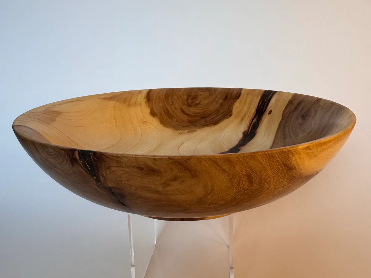 Side view of low apple wood bowl showing natural bark inclusion