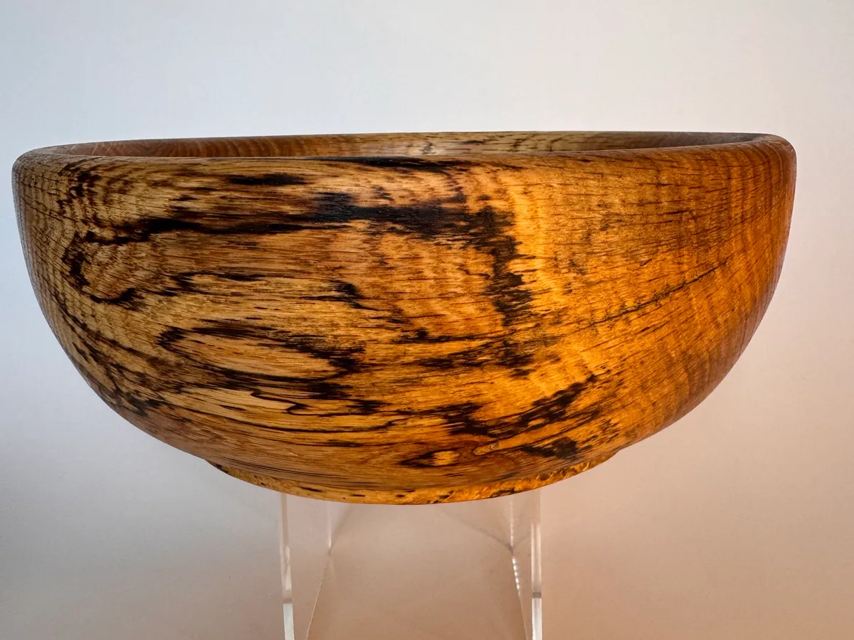Side view of a hand-turned spalted oak bowl