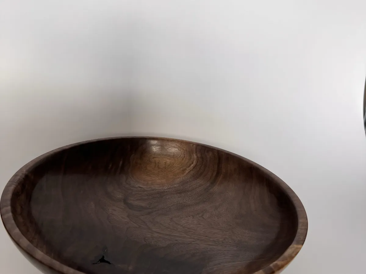 Angled view of black walnut bowl showing the broad rim and warm brown figure