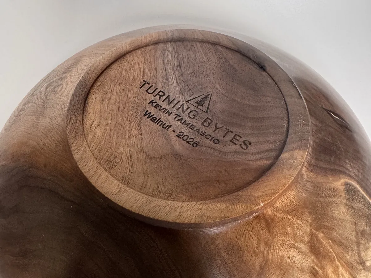 Bottom of black walnut bowl with Turning Bytes maker mark and small raised foot