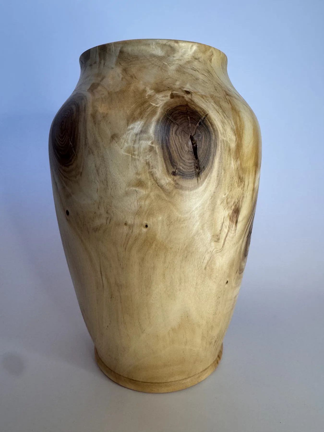 Front view of hand-turned maple vase with rounded shoulders and a natural knot feature