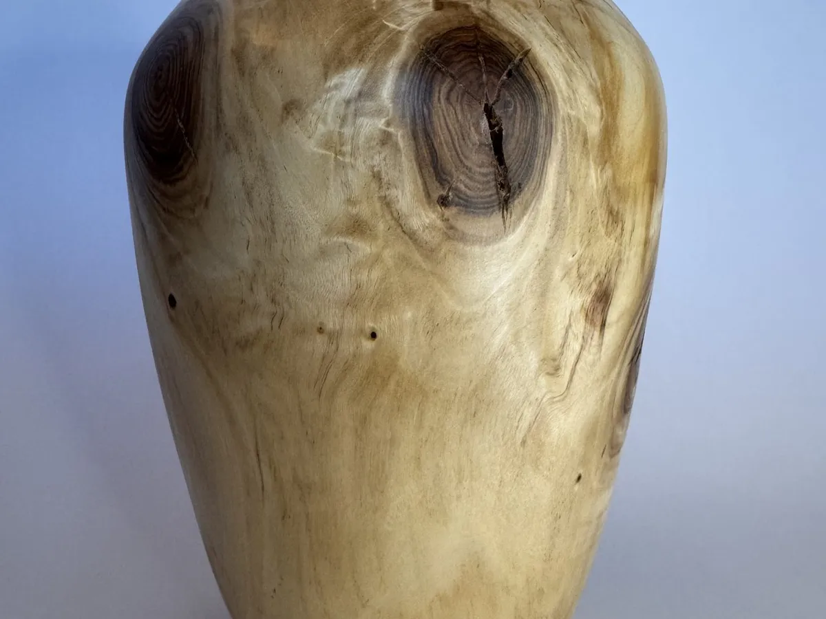 Front view of hand-turned maple vase with rounded shoulders and a natural knot feature