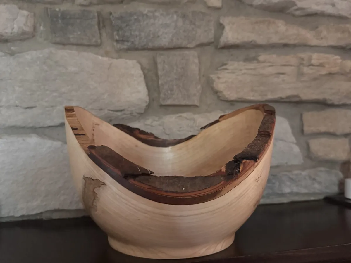 Maple natural edge bowl displayed on a mantel with raised winged sides