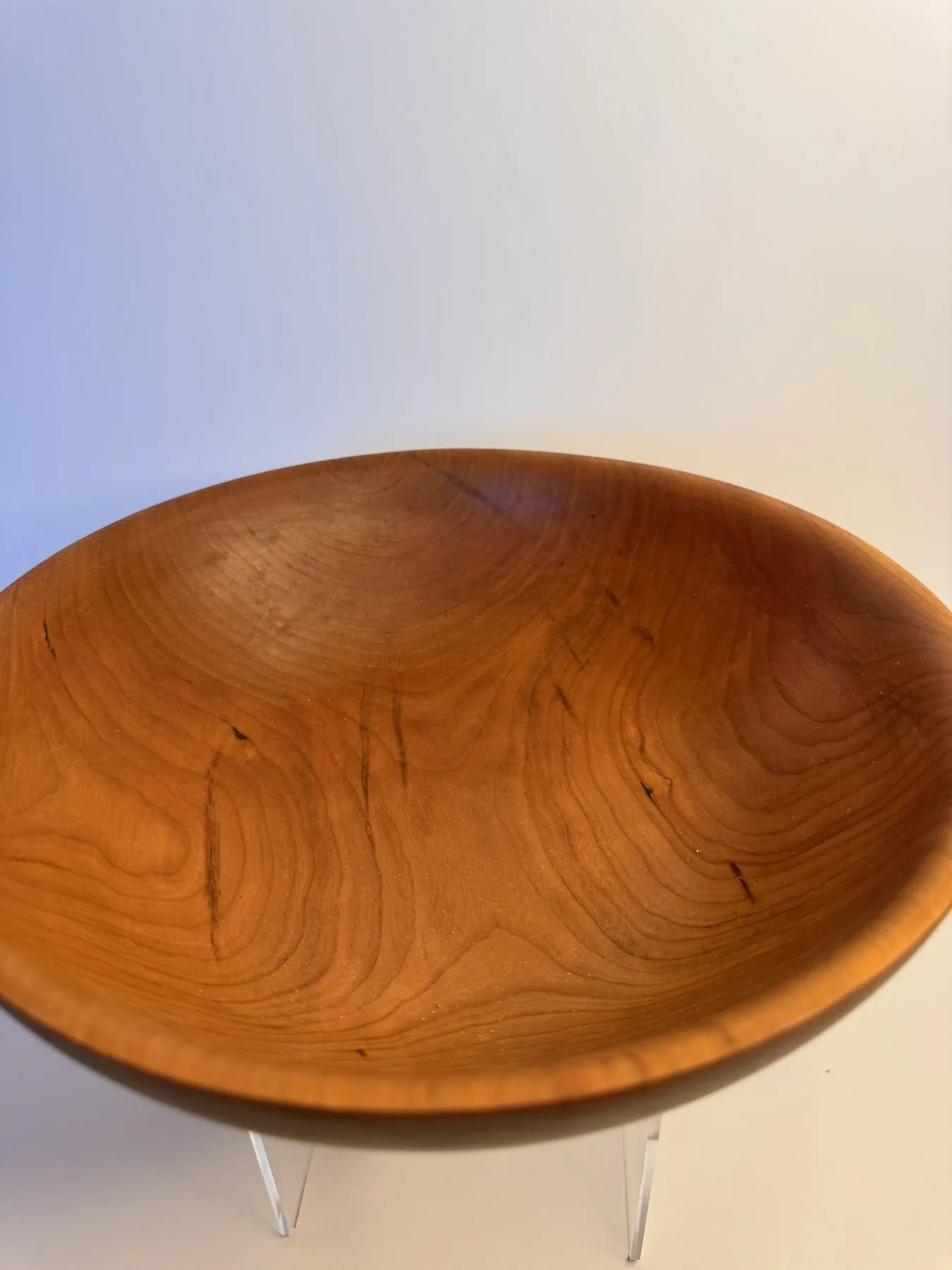 Interior view of cherry bowl showing warm grain and rounded rim
