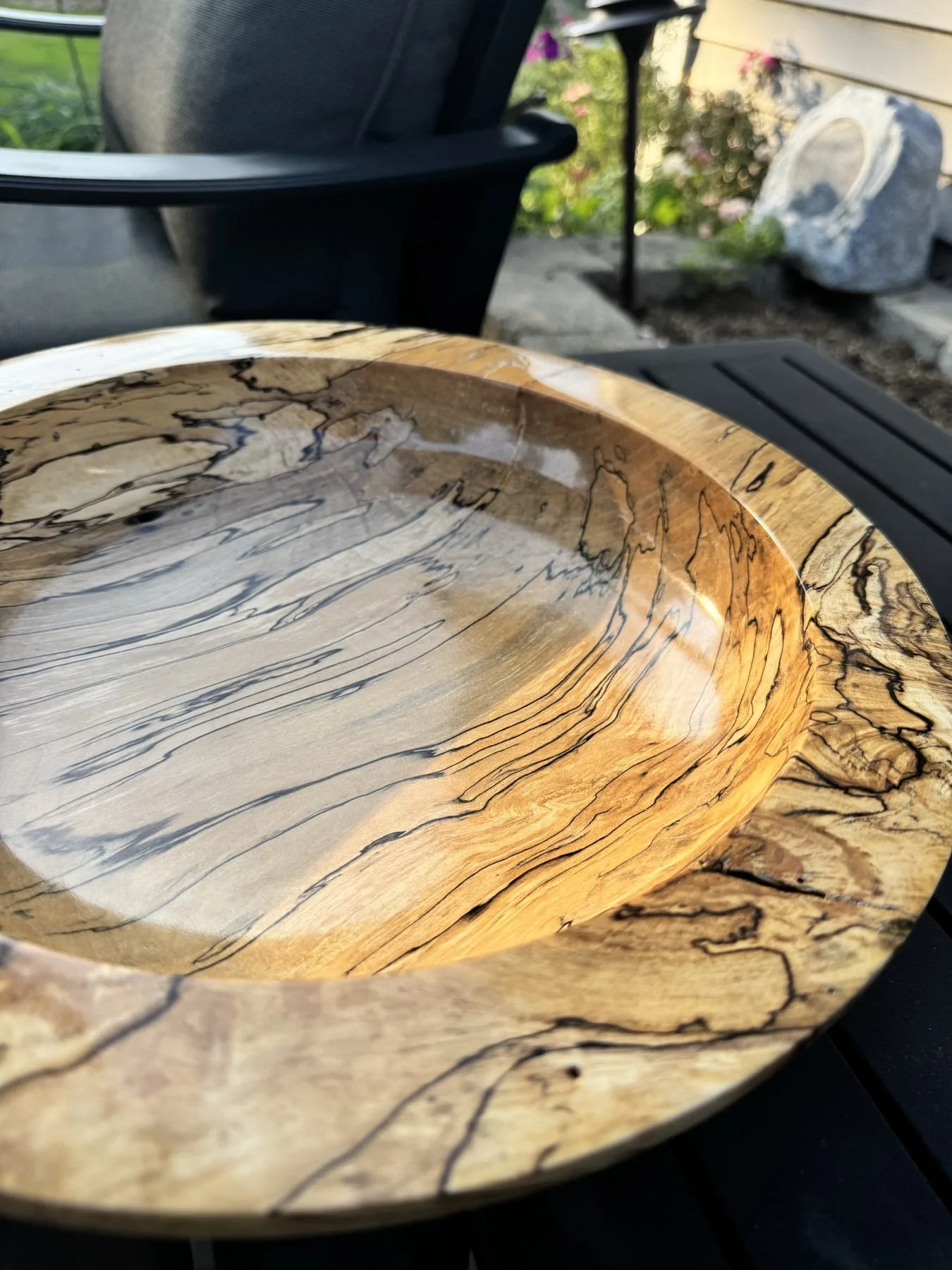 Outdoor natural light shot displaying glossy finish and bold black spalting zone lines