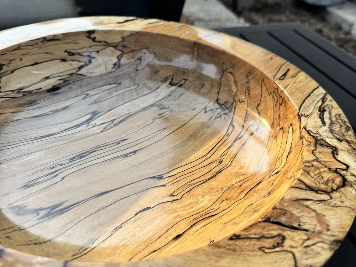 Outdoor natural light shot displaying glossy finish and bold black spalting zone lines