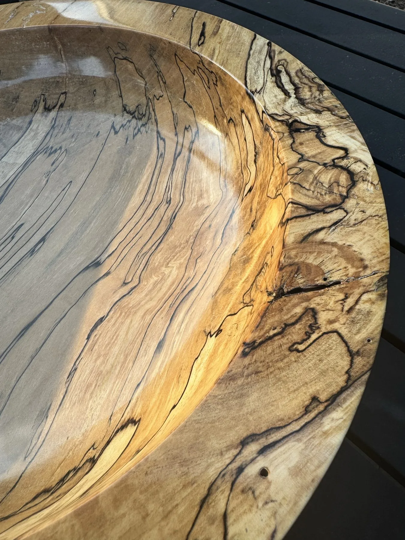 Close-up of the wide flat rim showing intricate ink-like fungal zone lines
