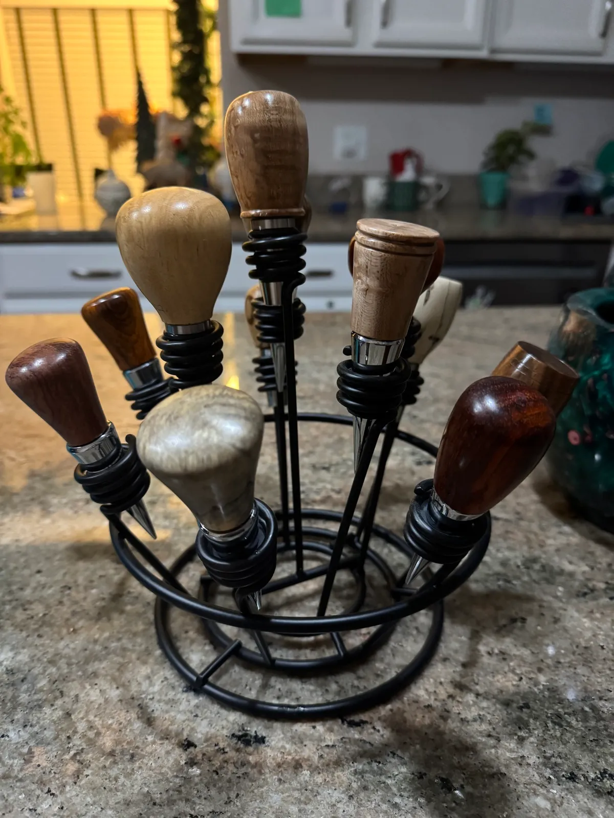 Hand-turned wood bottle stoppers displayed upright in a retail rack